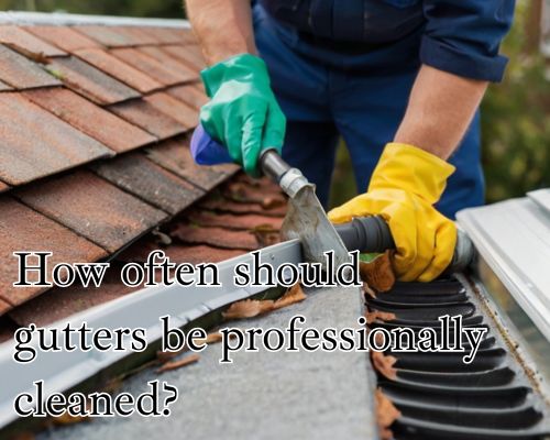 Gloved fingers clearing blocked gutter.
